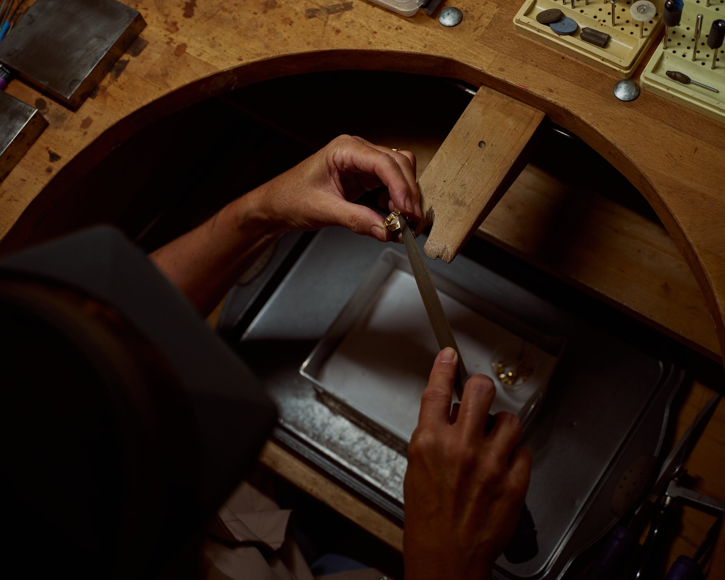 Filing a gold ring at the jeweller's bench