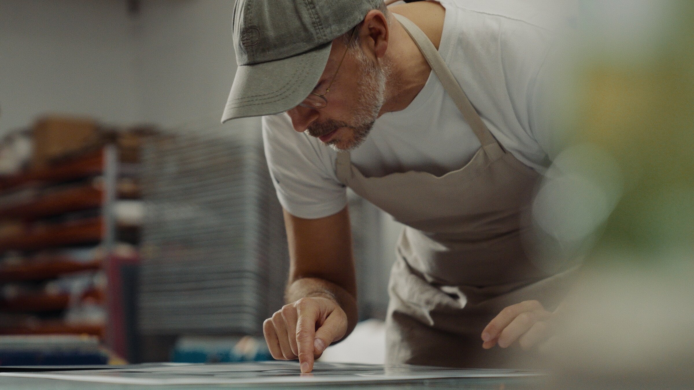 Hands preparing a screen-printing stencil