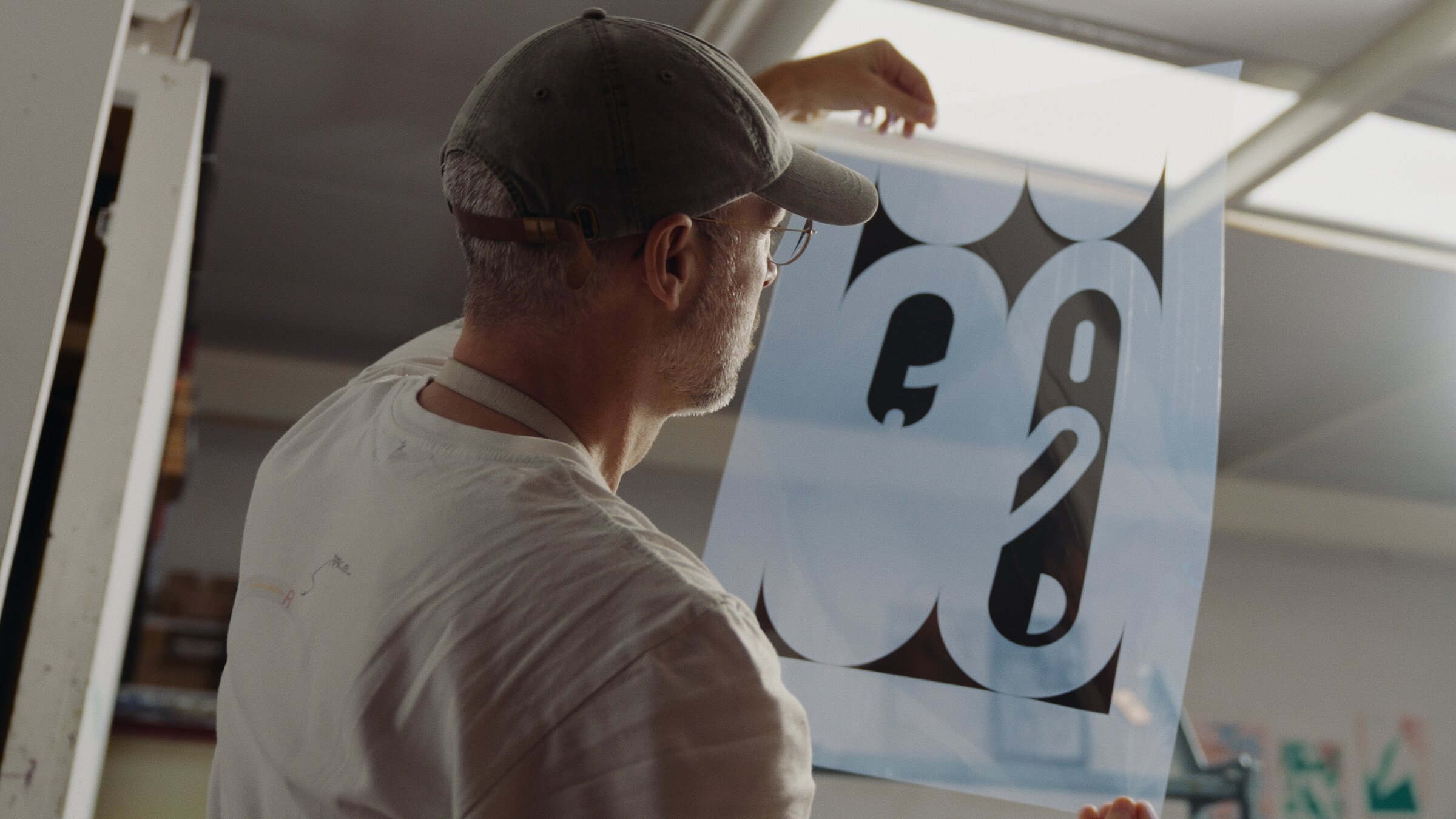 Pulling a print from the screen-printing press