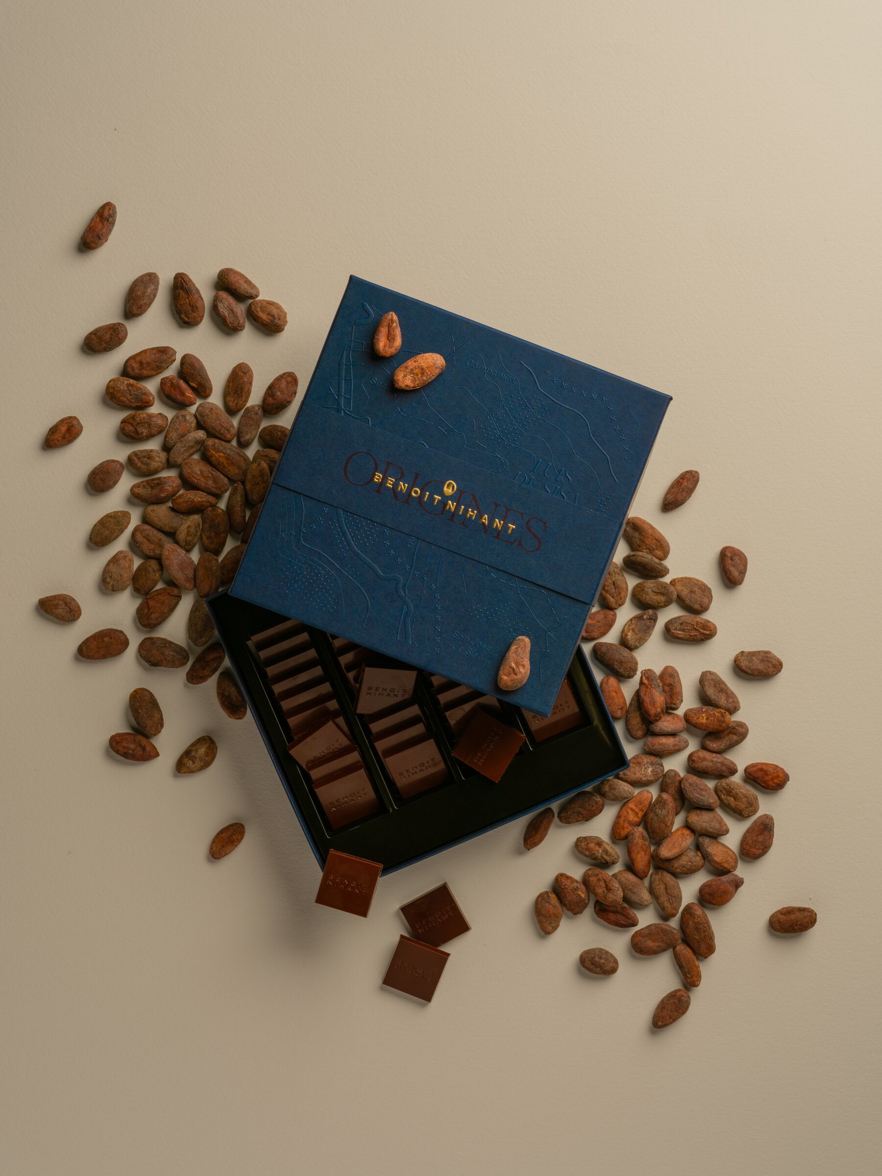 Benoît Nihant 'Origines' chocolate box open, surrounded by cocoa beans