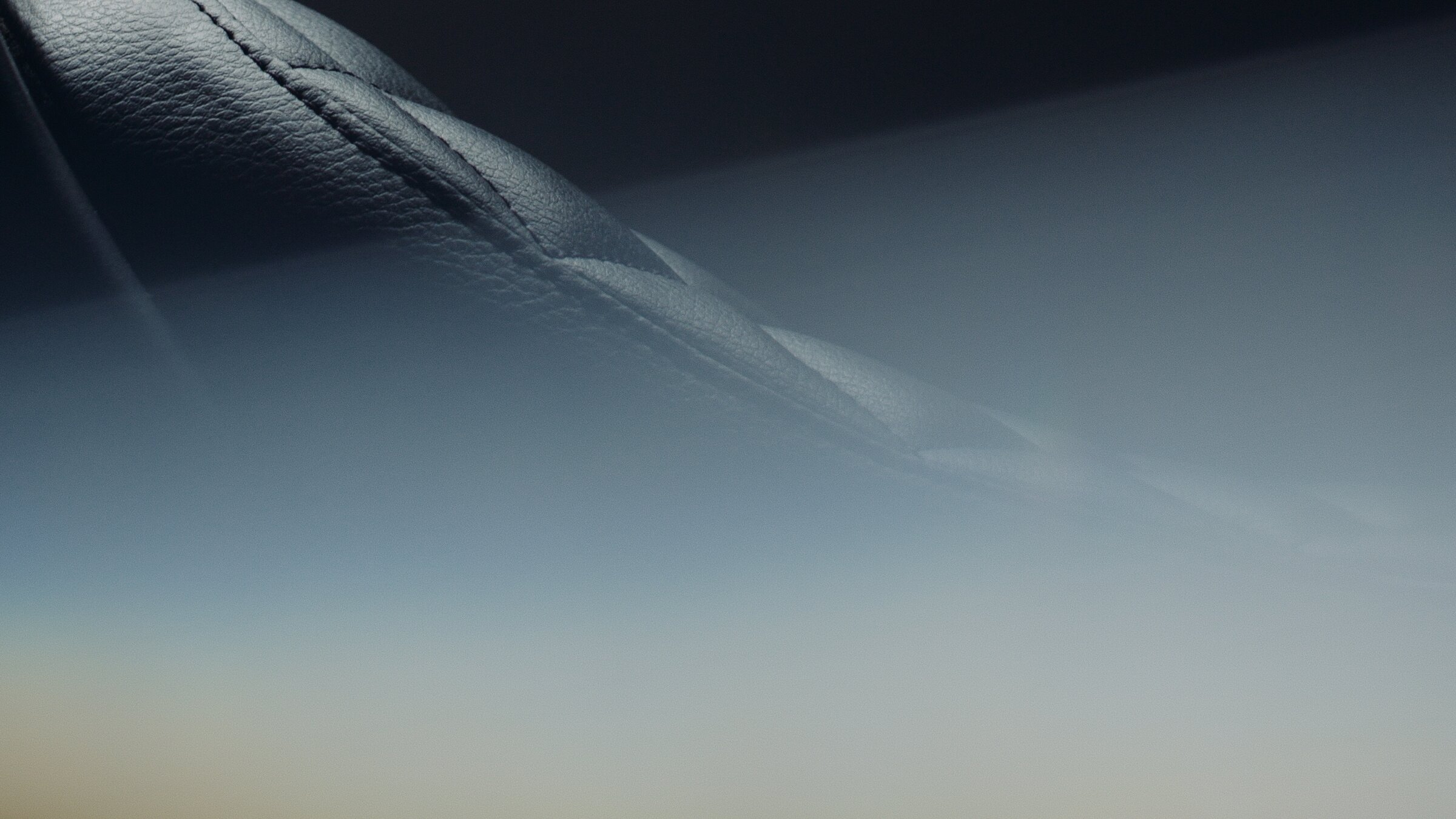 Abstract detail of stitched leather and light