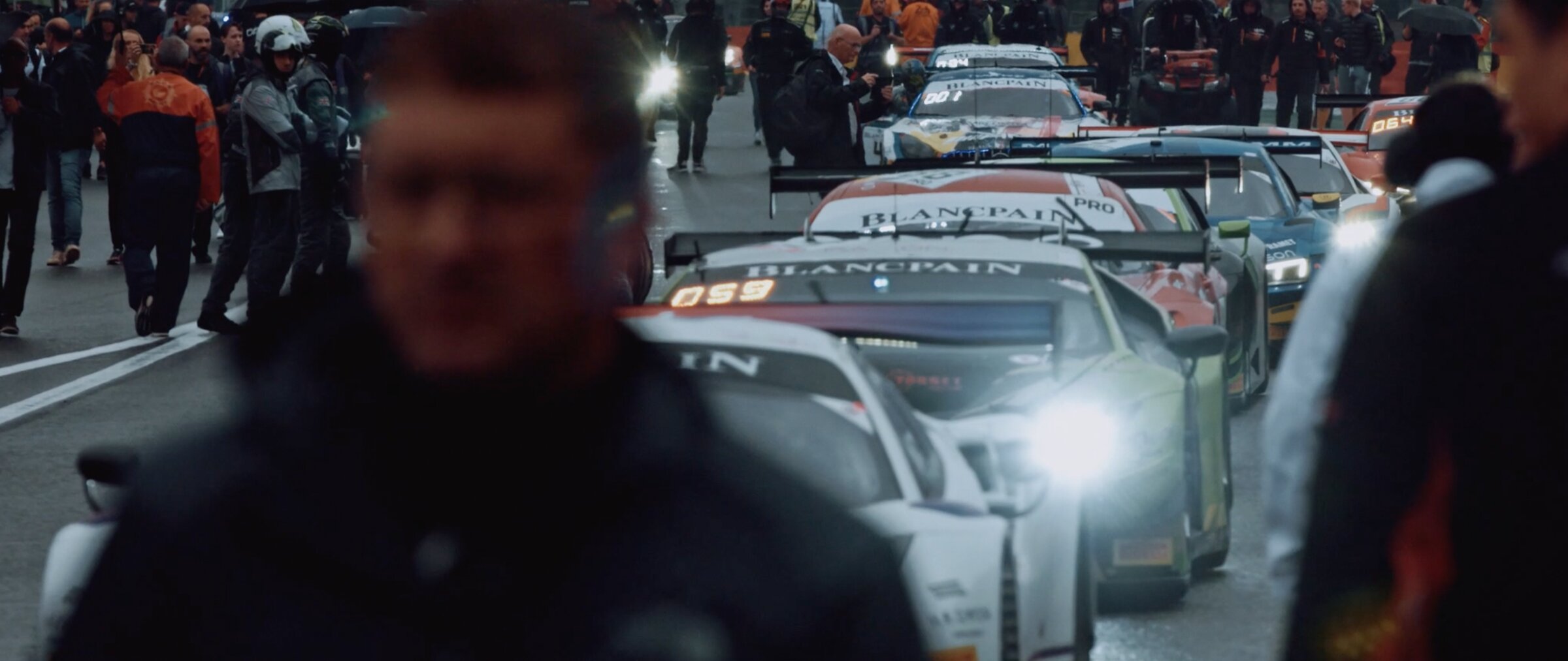 Grid walk in the rain, GT cars lined up, crowd of photographers