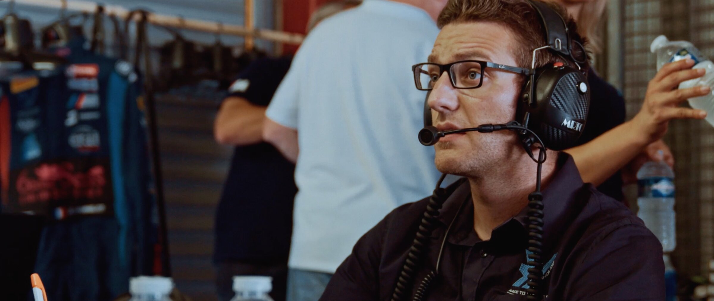 Team engineer with pit headset in the garage