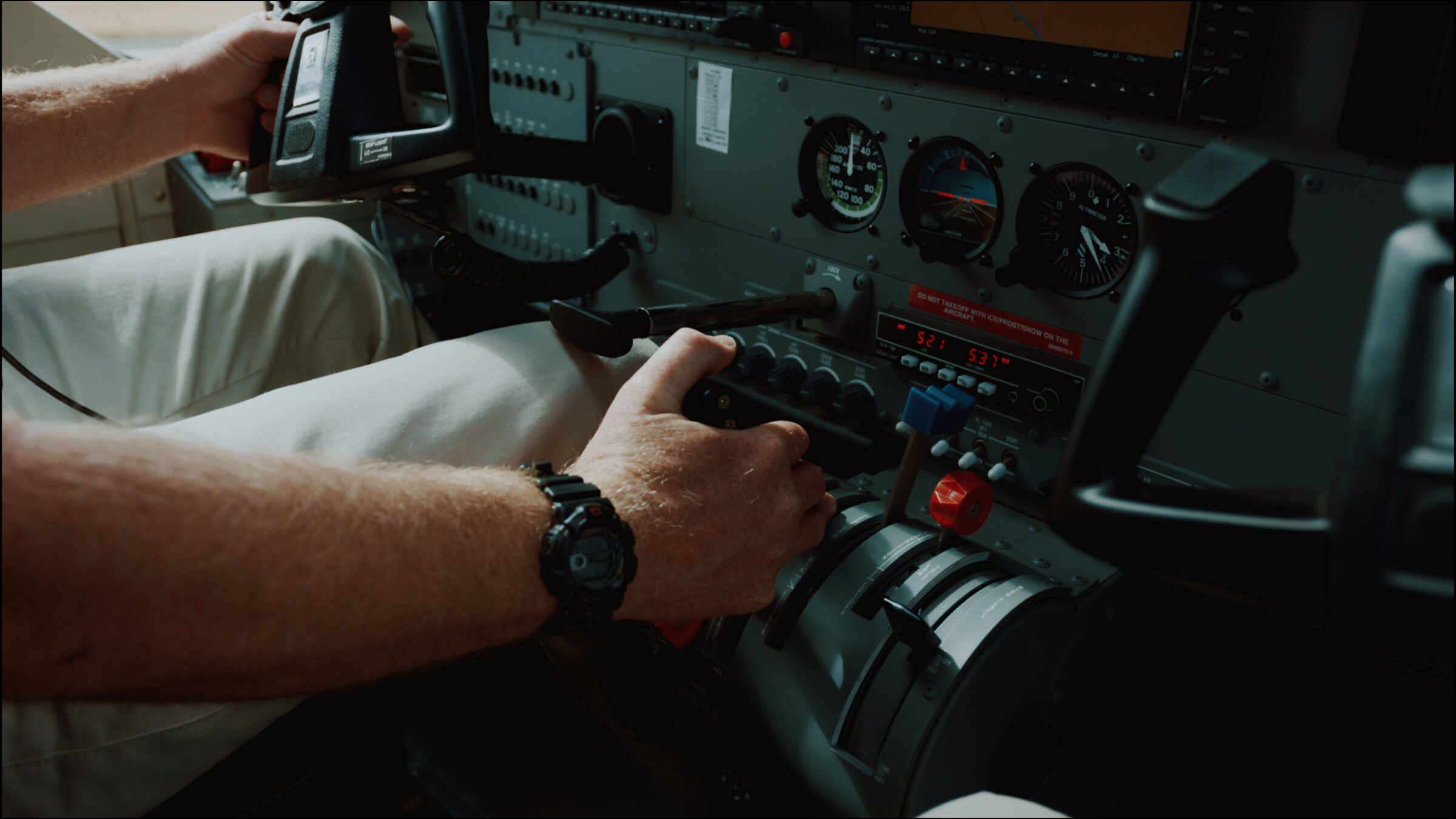 Bush plane cockpit, pilot's hands on the controls