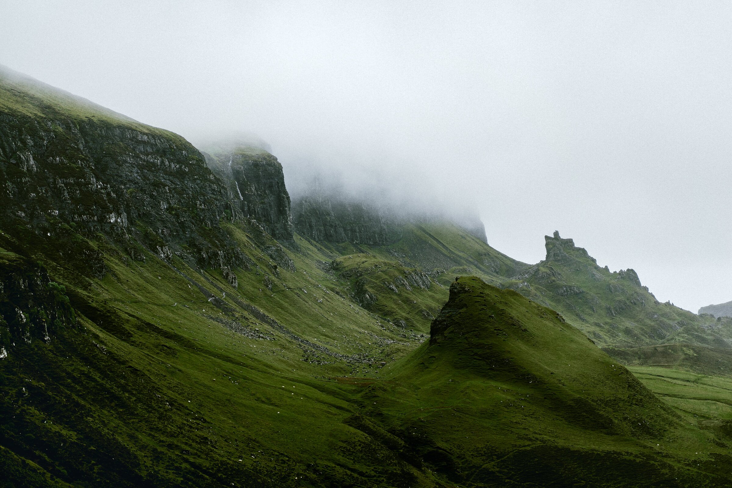 Fog-shrouded green cliffs, the Quiraing, Isle of Skye