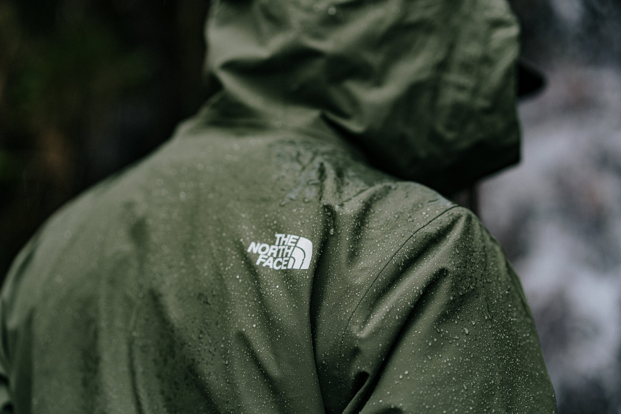 The North Face jacket detail, rain-soaked shoulder