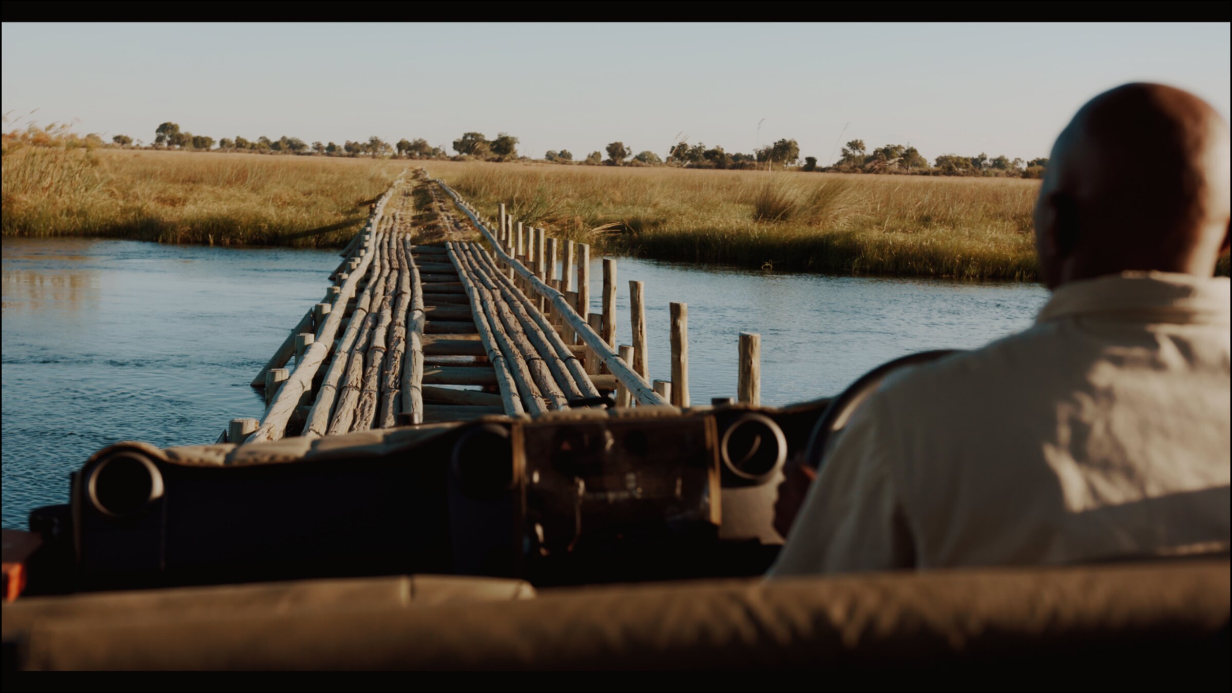 Safari vehicle crossing a flooded track
